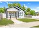 Charming home featuring a manicured lawn, light stone walkway, and welcoming front porch at 2511 W Braddock St, Tampa, FL 33607