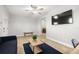 Bright living room featuring tile floors, ceiling fan, and flat screen television at 2511 W Braddock St, Tampa, FL 33607