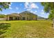 Expansive backyard with lush lawn, patio area, and secure fencing, ideal for recreation and privacy at 26249 Sword Dancer Dr, Wesley Chapel, FL 33544