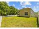 Expansive green backyard featuring white fences, providing ample space and privacy at 26249 Sword Dancer Dr, Wesley Chapel, FL 33544