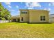 Spacious backyard featuring a covered patio and well-maintained lawn, great for outdoor enjoyment at 26249 Sword Dancer Dr, Wesley Chapel, FL 33544