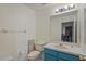 Powder room with single sink, painted vanity and tile flooring at 26249 Sword Dancer Dr, Wesley Chapel, FL 33544