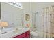 Bathroom with tiled shower and tub, vanity and mirror, and decorated with artwork at 26249 Sword Dancer Dr, Wesley Chapel, FL 33544