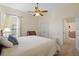 Bedroom with carpet, ceiling fan, traditional furniture, a window and closet at 26249 Sword Dancer Dr, Wesley Chapel, FL 33544
