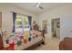 Comfortable bedroom with a window, a bed with quilt, and a door to the bathroom at 26249 Sword Dancer Dr, Wesley Chapel, FL 33544