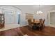 Dining room with chandelier and access to the living room and front entry at 26249 Sword Dancer Dr, Wesley Chapel, FL 33544