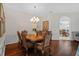 Dining room featuring hardwood floors, a chandelier, and access to the kitchen at 26249 Sword Dancer Dr, Wesley Chapel, FL 33544