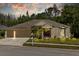 Inviting single-story home featuring a well-manicured lawn and attached three-car garage at 26249 Sword Dancer Dr, Wesley Chapel, FL 33544