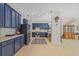 Spacious kitchen with blue cabinets, stainless steel appliances and tile backsplash at 26249 Sword Dancer Dr, Wesley Chapel, FL 33544