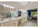 Large bathroom with double sinks, tub, and views to the main bedroom at 26249 Sword Dancer Dr, Wesley Chapel, FL 33544