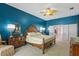 Spacious main bedroom with ensuite bathroom access and a wooden dresser and accents at 26249 Sword Dancer Dr, Wesley Chapel, FL 33544