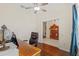 Bright office space featuring a classic wooden desk, hardwood floors, and ample natural light at 26249 Sword Dancer Dr, Wesley Chapel, FL 33544
