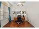 Bright office space featuring a classic wooden desk, hardwood floors, and ample natural light at 26249 Sword Dancer Dr, Wesley Chapel, FL 33544
