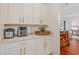 Pantry area featuring bright white cabinets with stainless steel appliances at 26249 Sword Dancer Dr, Wesley Chapel, FL 33544
