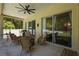 Covered patio with ceiling fan, outdoor furniture, and sliding glass doors at 26249 Sword Dancer Dr, Wesley Chapel, FL 33544