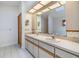 The bathroom includes double sinks with wallpapered accent walls and tile flooring at 2664 Frisco Dr, Clearwater, FL 33761