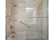 Updated bath with sleek glass door shower, grab bars, and tiled walls at 2664 Frisco Dr, Clearwater, FL 33761