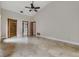 A spacious bedroom with high ceilings, tile floors, and access to a walk-in closet and a bathroom at 2664 Frisco Dr, Clearwater, FL 33761