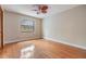 This simple bedroom offers neutral paint, light hardwood floors, and a ceiling fan at 2664 Frisco Dr, Clearwater, FL 33761