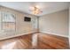Well-lit bedroom features hardwood flooring, neutral walls, and a ceiling fan at 2664 Frisco Dr, Clearwater, FL 33761