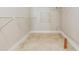 This walk-in closet has built-in shelving and tile flooring for easy organization at 2664 Frisco Dr, Clearwater, FL 33761