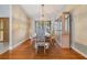 Bright dining area with hardwood floors, a display cabinet, and a window with blinds at 2664 Frisco Dr, Clearwater, FL 33761