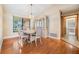 Cozy dining area featuring a wooden table set, a display cabinet, and hardwood floors at 2664 Frisco Dr, Clearwater, FL 33761