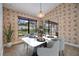 The dining room has a view of the pool, tile floors, and neutral wallpaper at 2664 Frisco Dr, Clearwater, FL 33761