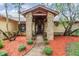 Inviting front entrance featuring brick pillars, well-maintained landscaping, and a charming wooden front door at 2664 Frisco Dr, Clearwater, FL 33761