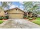 A well-maintained single-Gathering home with a two-car garage, tidy landscaping, and manicured front yard at 2664 Frisco Dr, Clearwater, FL 33761