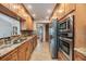 This updated kitchen features stainless appliances, granite countertops, and wood cabinets at 2664 Frisco Dr, Clearwater, FL 33761