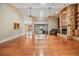 Open living room featuring hardwood floors, a stone fireplace with shelving, and access to an outdoor pool area at 2664 Frisco Dr, Clearwater, FL 33761