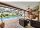 Screened-in lanai with pool, lounge area, and tiki bar, perfect for outdoor entertaining at 2664 Frisco Dr, Clearwater, FL 33761