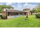 Enjoy a refreshing pool in a private, screened-in patio, surrounded by a well-manicured lawn and inviting outdoor seating at 2664 Frisco Dr, Clearwater, FL 33761