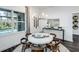 Bright dining room with modern chandelier and decorative wall art, next to a window looking to the pool at 27052 Paradise Shores Dr, Englewood, FL 34223