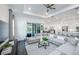 Bright living room featuring a large sectional sofa, stylish furnishings, and open access to the kitchen at 27052 Paradise Shores Dr, Englewood, FL 34223