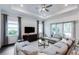 Comfortable living room with a coffered ceiling, large sectional sofa, and sliding glass doors to the outside at 27052 Paradise Shores Dr, Englewood, FL 34223