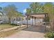 Charming single-story home with a screened porch, carport, brick walkway, and landscaped yard at 2821 Marconi St, Tampa, FL 33605