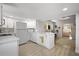 Bright kitchen featuring white cabinetry, stainless steel appliances, and direct access to the living room at 2821 Marconi St, Tampa, FL 33605