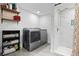 Laundry room with a modern washer and dryer, storage shelves, and a walk-in shower at 2821 Marconi St, Tampa, FL 33605