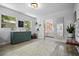 Bright and stylish sitting room with a cabinet, wooden floors, and an open view to the living area at 2821 Marconi St, Tampa, FL 33605