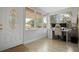 Bright sunroom with large windows, a white desk, and a comfortable chair, perfect for a home office at 2821 Marconi St, Tampa, FL 33605