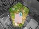 Highlighted aerial view of property with screened-in pool, lush greenery and proximity to a serene pond at 3728 Cypress Meadows Rd, Tampa, FL 33624