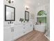 Bright bathroom featuring double vanity, soaking tub, and glass-enclosed shower at 3728 Cypress Meadows Rd, Tampa, FL 33624