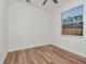 Bright bedroom featuring wood-look floors, neutral walls, and natural light from the window at 3728 Cypress Meadows Rd, Tampa, FL 33624