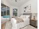 Bedroom features natural light and sliding glass doors to a screened-in pool at 3728 Cypress Meadows Rd, Tampa, FL 33624