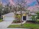 Charming single-story home with mature landscaping, a circular driveway, and a well-manicured lawn at 3728 Cypress Meadows Rd, Tampa, FL 33624