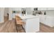 Modern kitchen featuring a large island, white cabinets, stainless steel appliances, and stylish bar stools at 3728 Cypress Meadows Rd, Tampa, FL 33624