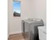 Laundry room with side-by-side washer and dryer, a utility sink and a window for natural light at 3728 Cypress Meadows Rd, Tampa, FL 33624