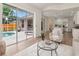 Open living room featuring sliding glass doors to a screened pool and an adjacent, open kitchen at 3728 Cypress Meadows Rd, Tampa, FL 33624